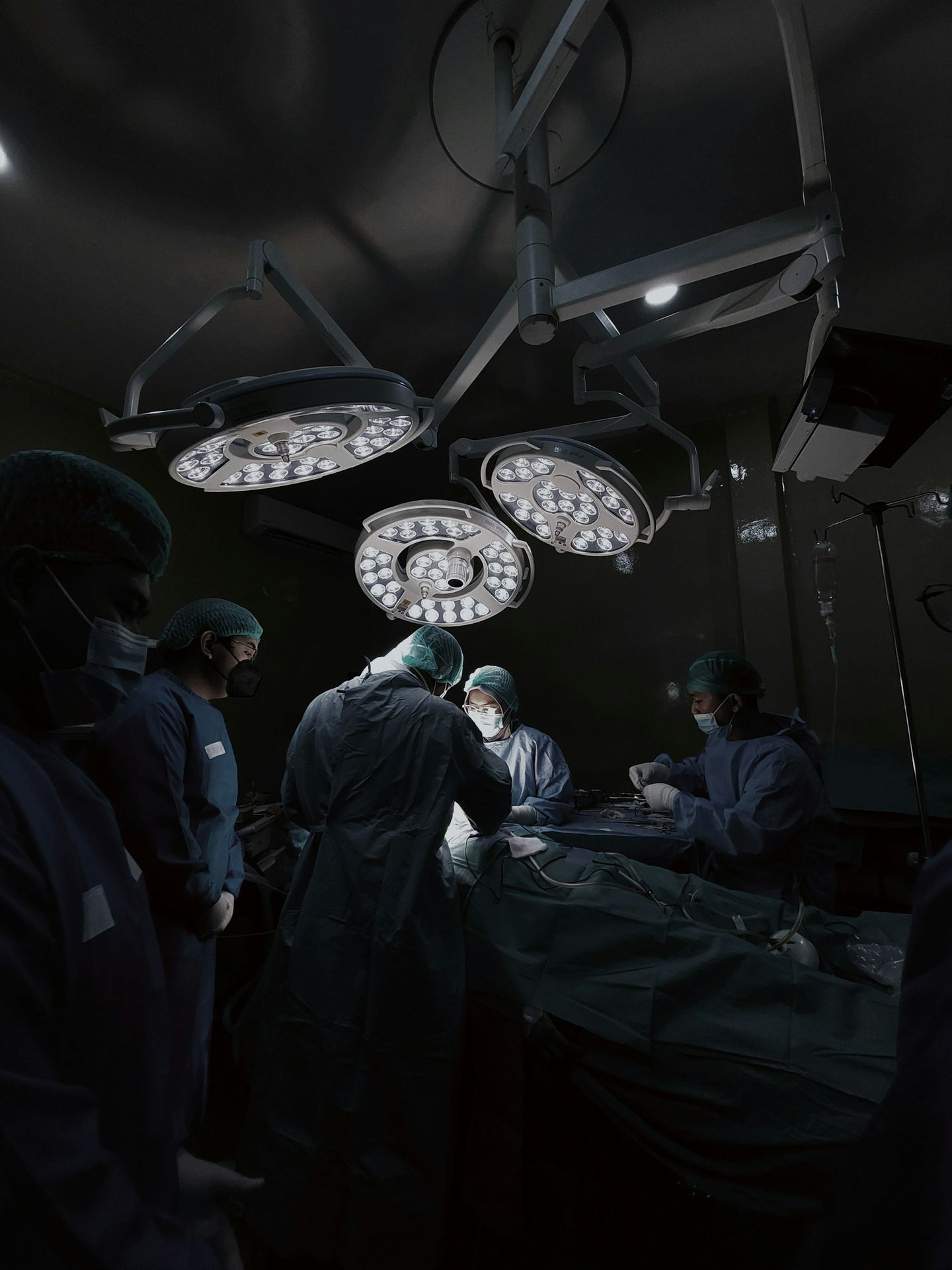 A group of doctors standing around a hospital bed
